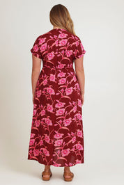 Model Chanel wearing size 16 of the Wild Garden Maxi Dress in colour Plumfleur (Pink), from the back