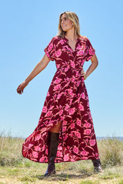 Model Tegan wearing size 10 of the Wild Garden Maxi Dress in colour Plumfleur (Pink), from the front, showing the whole outfit