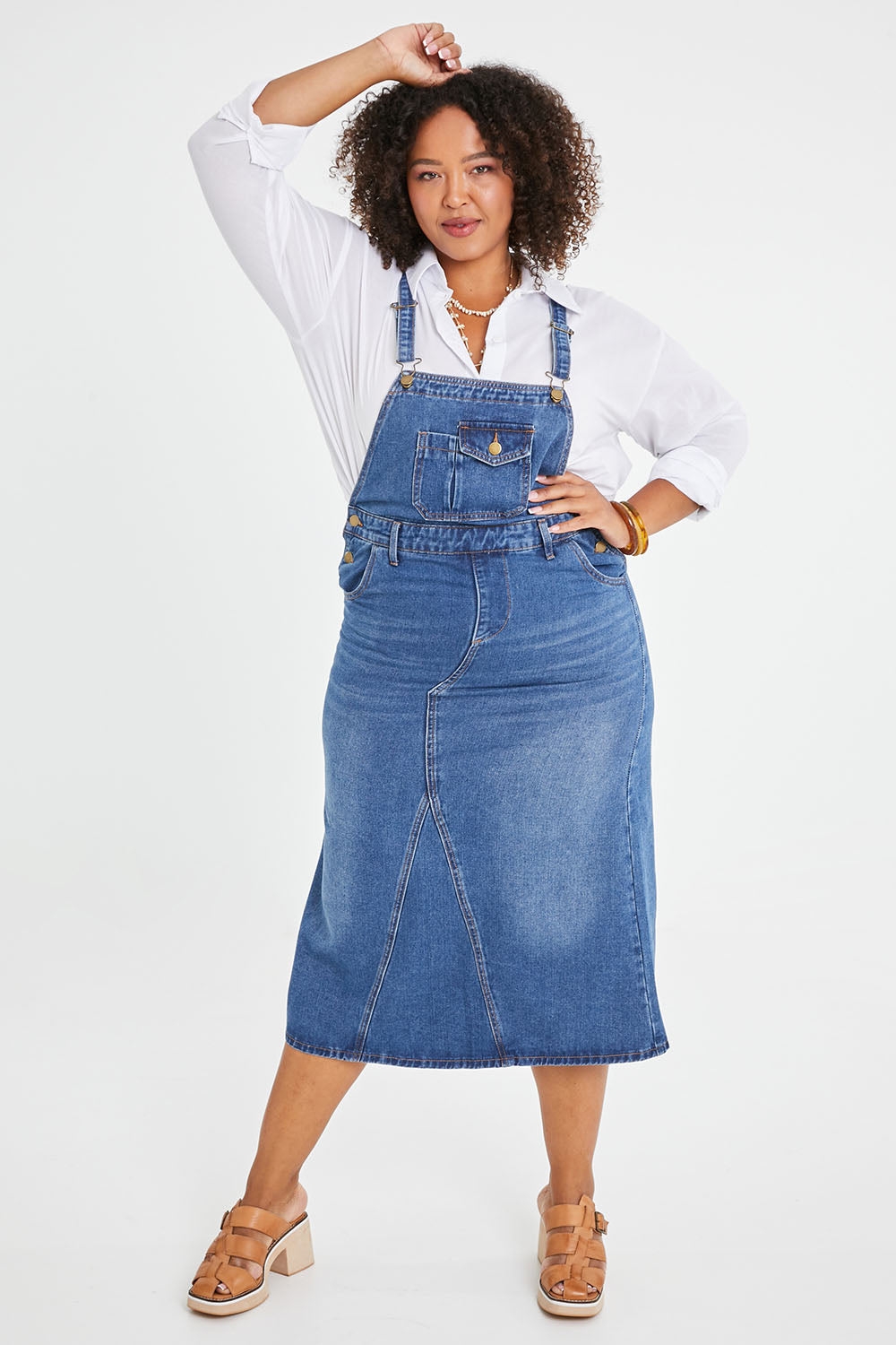 Model Alexis wearing size 16 of the Overall Happiness Dress in colour Denim (Blue), from the front, showing the whole outfit