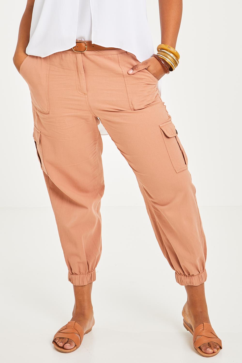 Model Noli wearing size 14 of the Travel With You Cargo Pants in colour Dust, from the front, cropped image