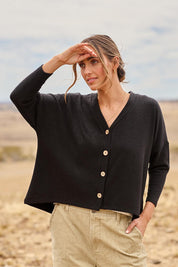 Model Tegan wearing size 10 of the My Boyfriends Slouch Cardi in colour Black (Black), from the front, showing the whole outfit