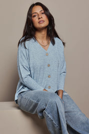 Model Tahnee wearing size 10 of the My Boyfriends Slouch Cardi in colour Skymarl (Blue), from the front, cropped image