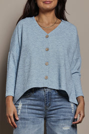 Model Tahnee wearing size 10 of the My Boyfriends Slouch Cardi in colour Skymarl (Blue), from the front, cropped image