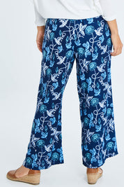 Model Cara wearing size 10 of the My Heart Is Full Flower Pants in colour Deepblue (Blue), from the back