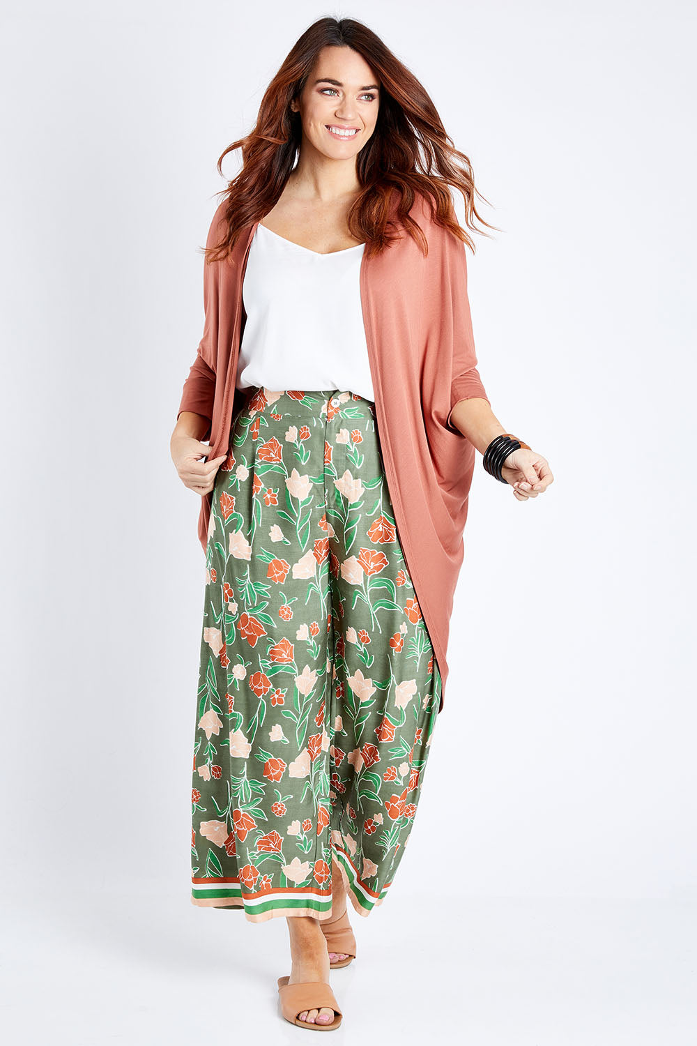 Model Laura wearing size 14 of the My Heart Is Full Flower Pants in colour Khaki (Green), from the front, showing the whole outfit