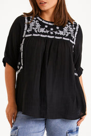 Model Monique wearing size 14 of the Secret Garden Cotton Blouse in colour Black (Black), from the front, cropped image