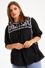 Model Monique wearing size 14 of the Secret Garden Cotton Blouse in colour Black (Black), from the front, cropped image