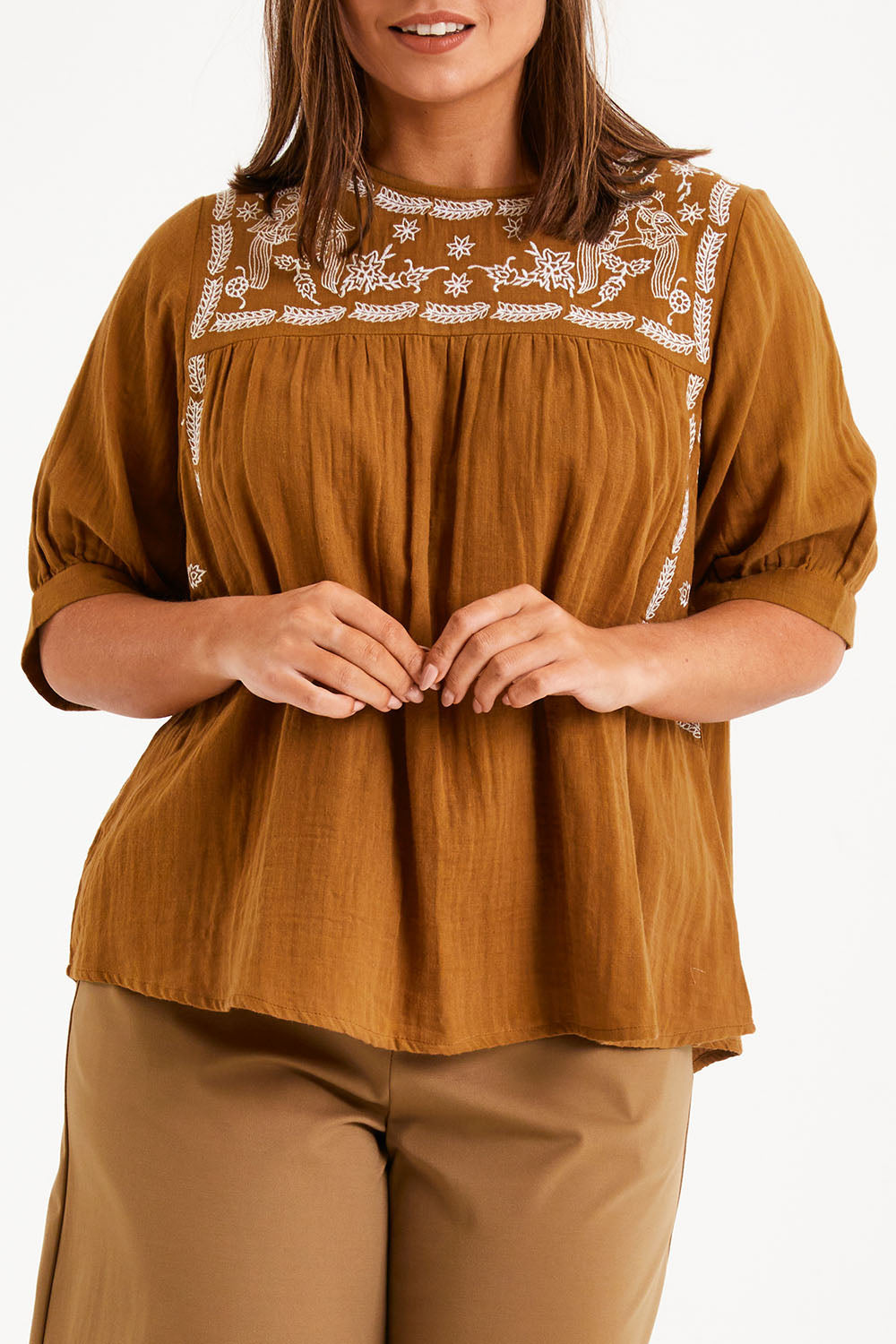 Model Monique wearing size 14 of the Secret Garden Cotton Blouse in colour Clay, from the front, cropped image