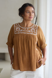 Model Tahnee wearing size 10 of the Secret Garden Cotton Blouse in colour Clay, from the front, showing the whole outfit