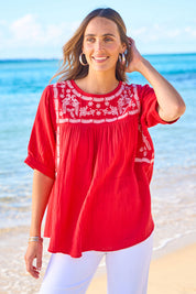 Model Tegan wearing size 10 of the Secret Garden Cotton Blouse in colour Scarlet (Red), from the front, showing the whole outfit