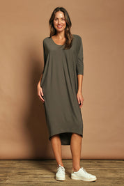 Model Madeline wearing size 10 of The Wanderer In Me Travel Dress in colour Khaki (Green), from the front, showing the whole outfit