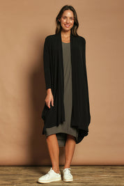 Model Madeline wearing size 10 of The Wanderer In Me Travel Dress in colour Khaki (Green), from the front, showing the whole outfit