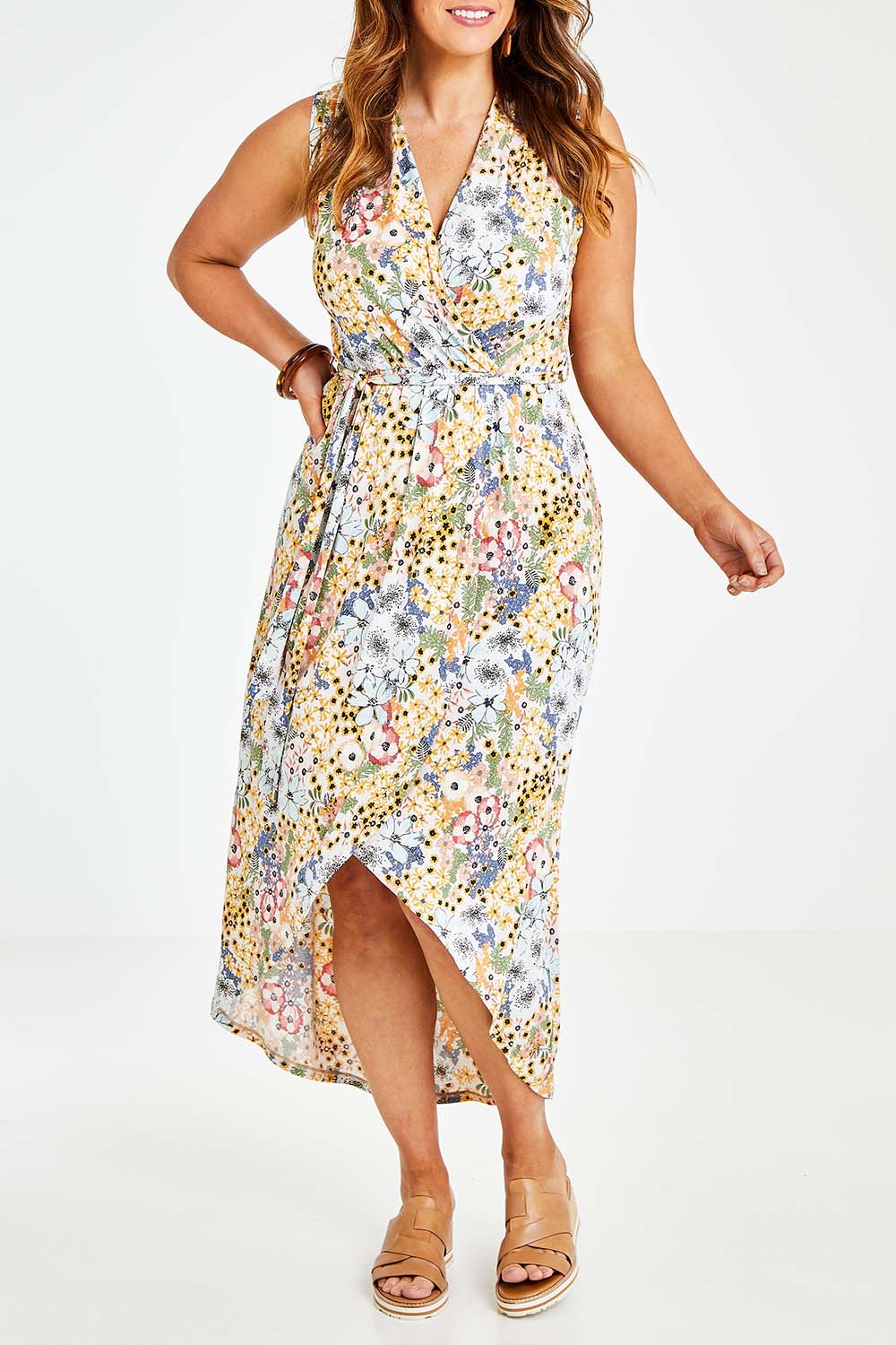 Model Laura wearing size 14 of the Freedom Faux Wrap Dress in colour Fleur, from the front, cropped image