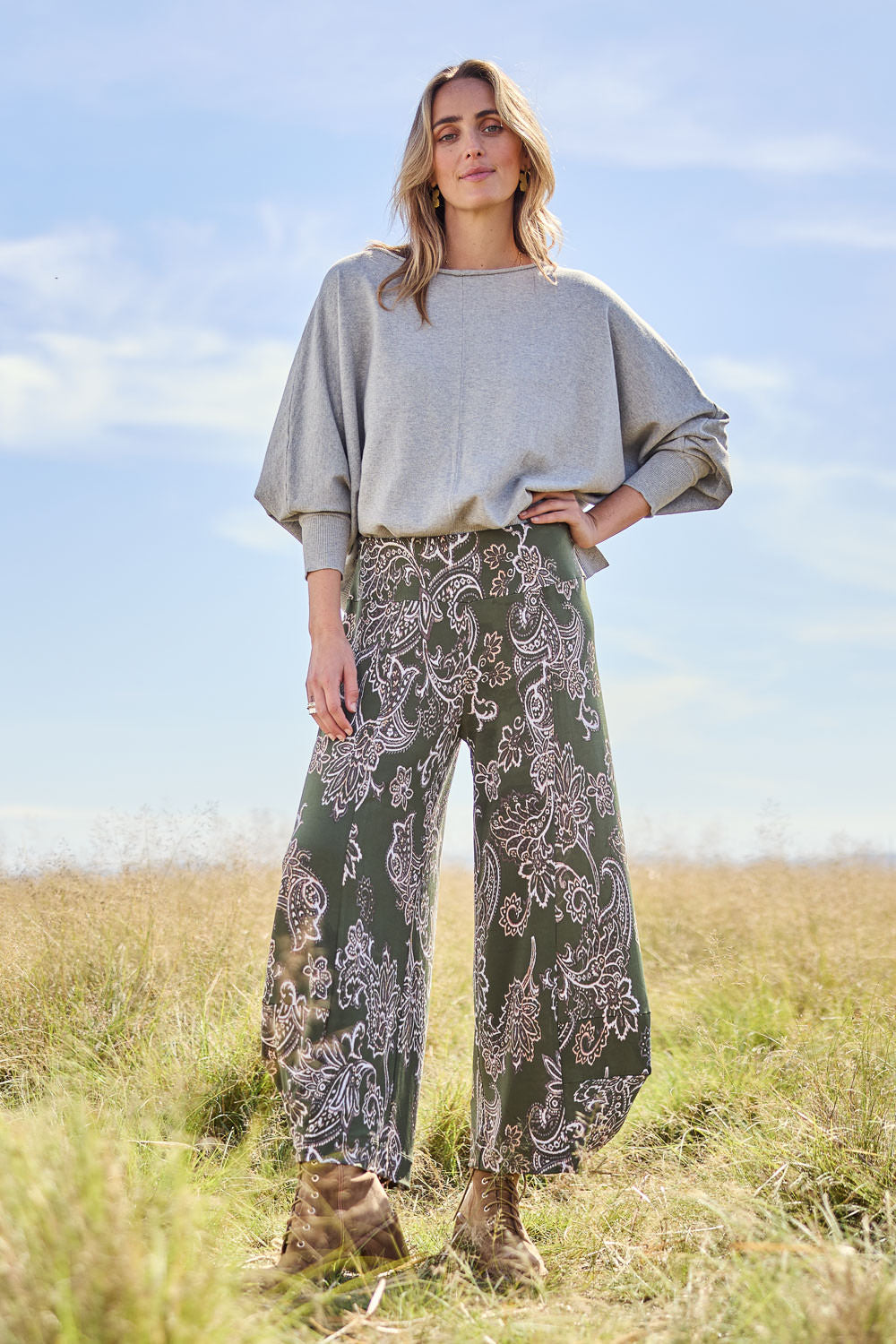 Model Chereen wearing size 10 of the Good Vibes Balloon Hem Pants in colour Greenpais (Green), from the front, showing the whole outfit