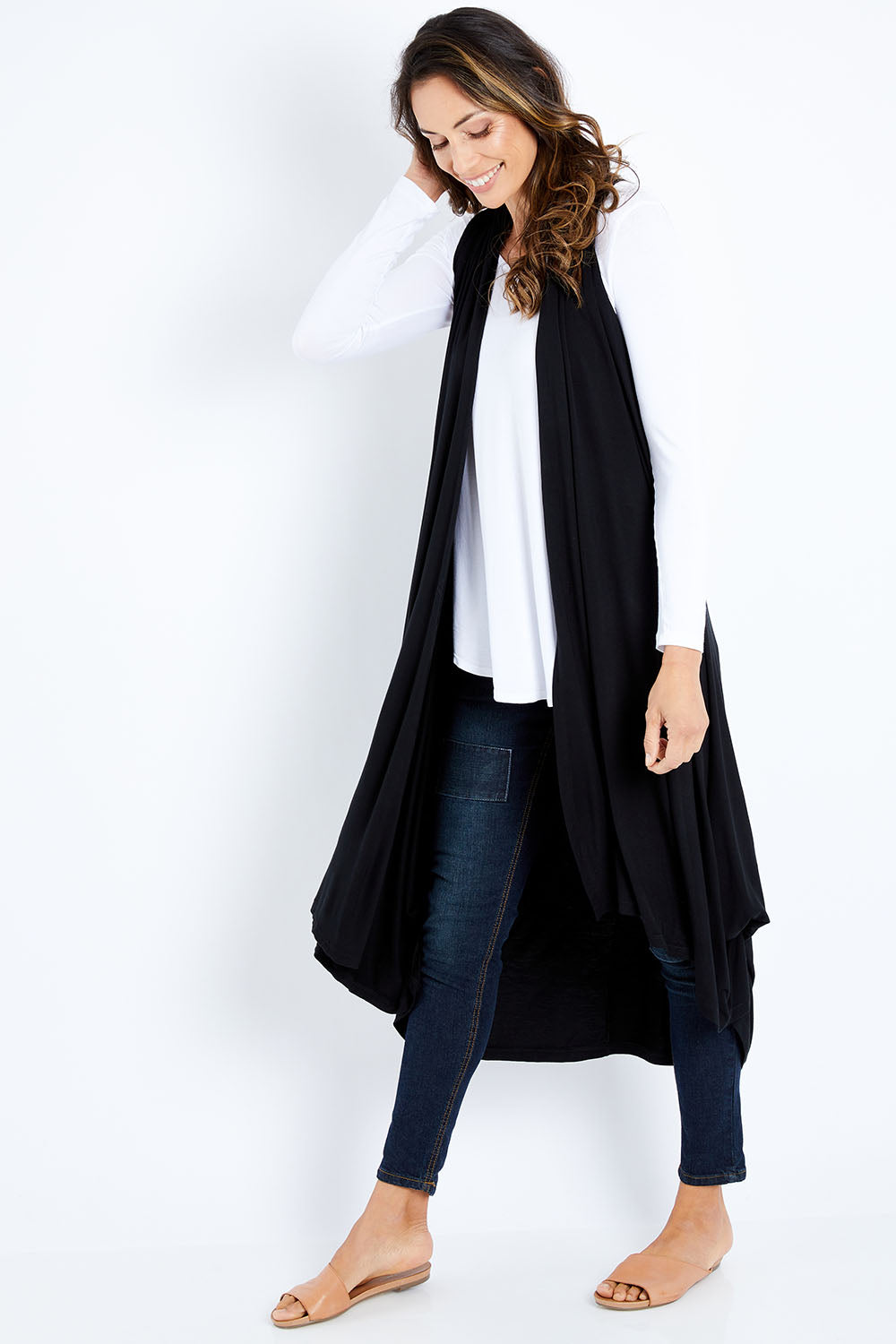Model Amanda wearing size 10 of the Softly Swinging Bamboo Vest in colour Black (Black), from the front, showing the whole outfit