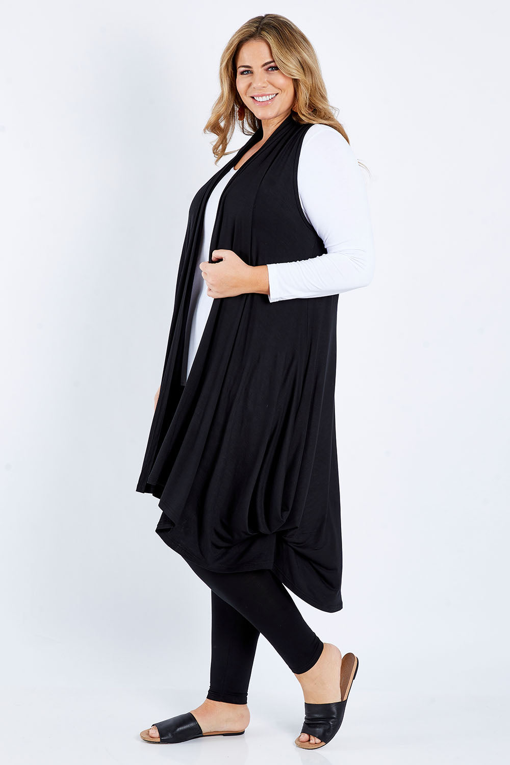 Model Fiona wearing size 16 of the Softly Swinging Bamboo Vest in colour Black (Black), from the front, showing the whole outfit