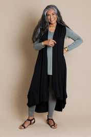 Model Nadine wearing size 10 of the Softly Swinging Bamboo Vest in colour Black (Black), from the front, showing the whole outfit