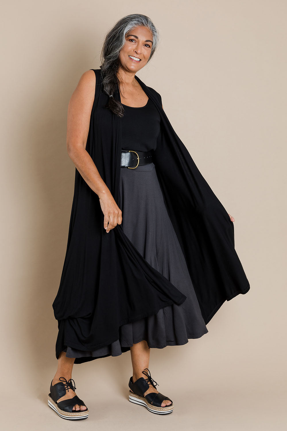 Model Nadine wearing size 10 of the Softly Swinging Bamboo Vest in colour Black (Black), from the front, showing the whole outfit