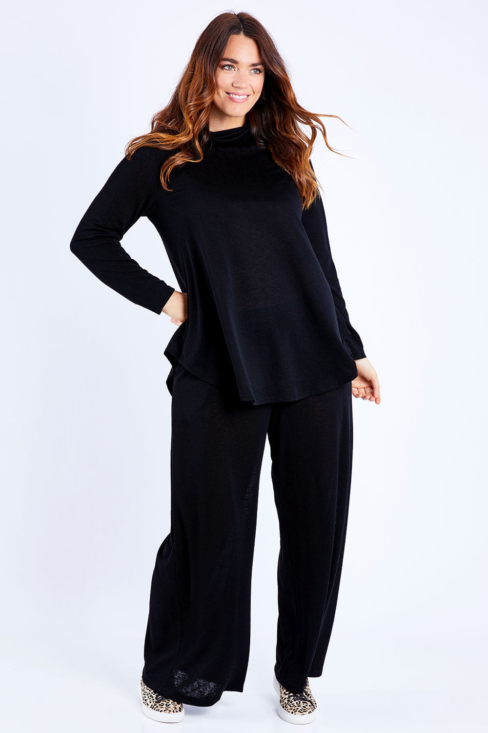 Model Laura wearing size 14 of the Falling For You Skivvy Tunic in colour Black (Black), from the front, showing the whole outfit