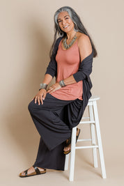 Model Nadine wearing size 10 of the Softly Swinging Bamboo Scoop Singlet in colour Copper, from the front, showing the whole outfit