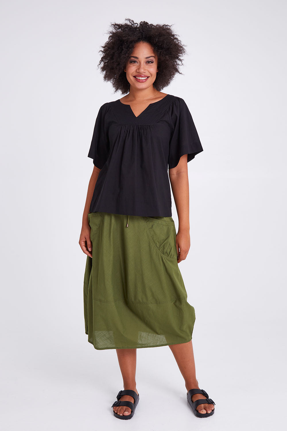 Model Olivia wearing size 10 of the Freya Top in colour Black (Black), from the front, showing the whole outfit