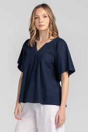 A model wearing the Freya Top in colour Navy (Blue), from the front, showing the whole outfit