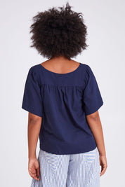 Model Olivia wearing size 10 of the Freya Top in colour Navy (Blue), from the back