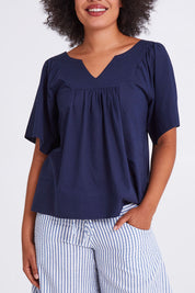 Model Olivia wearing size 10 of the Freya Top in colour Navy (Blue), from the front, cropped image