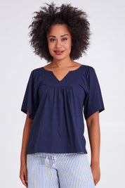 Model Olivia wearing size 10 of the Freya Top in colour Navy (Blue), from the front, cropped image