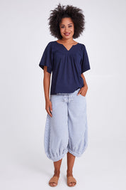 Model Olivia wearing size 10 of the Freya Top in colour Navy (Blue), from the front, showing the whole outfit