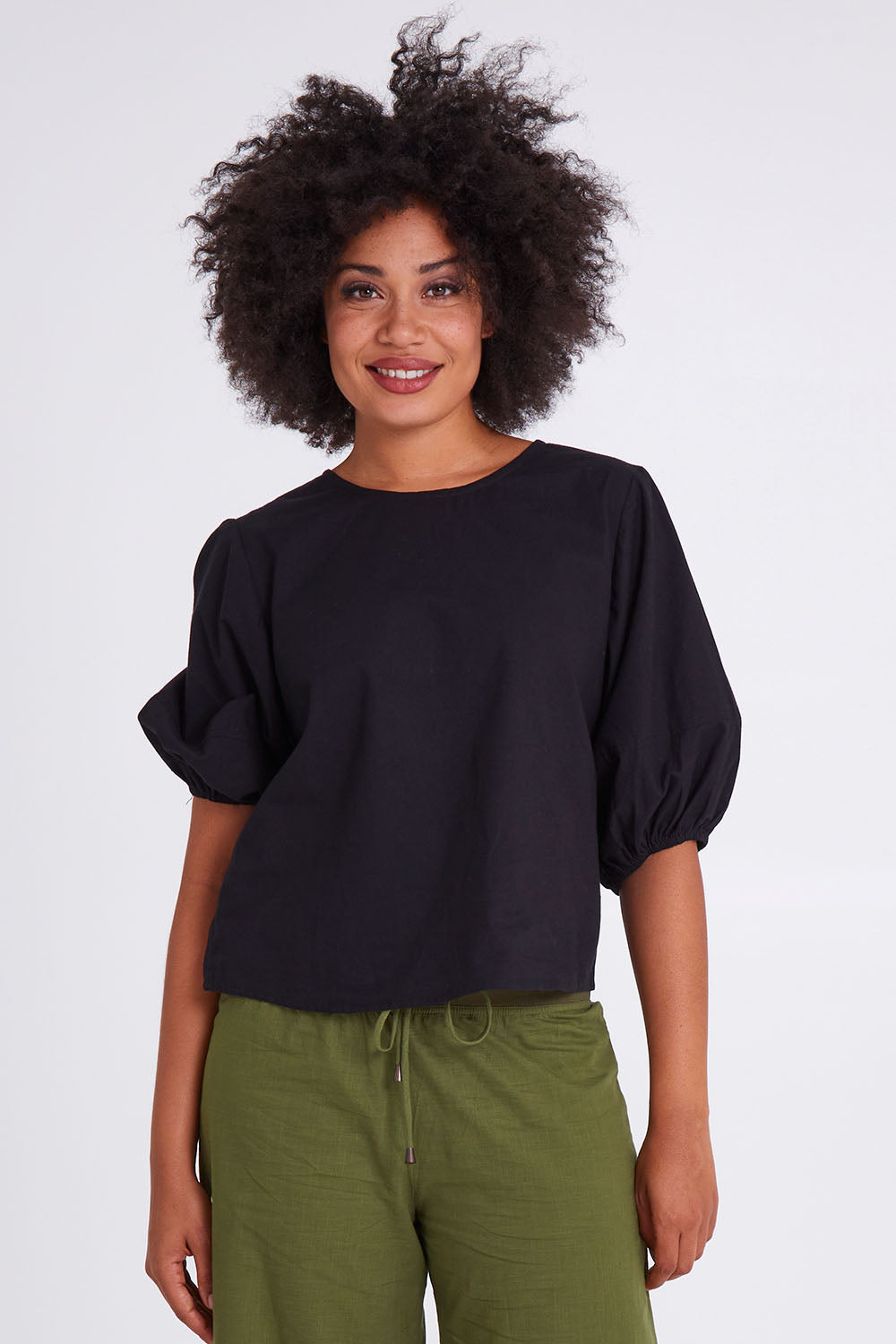 Model Olivia wearing size 10 of the Ava Top in colour Black (Black), from the front, cropped image