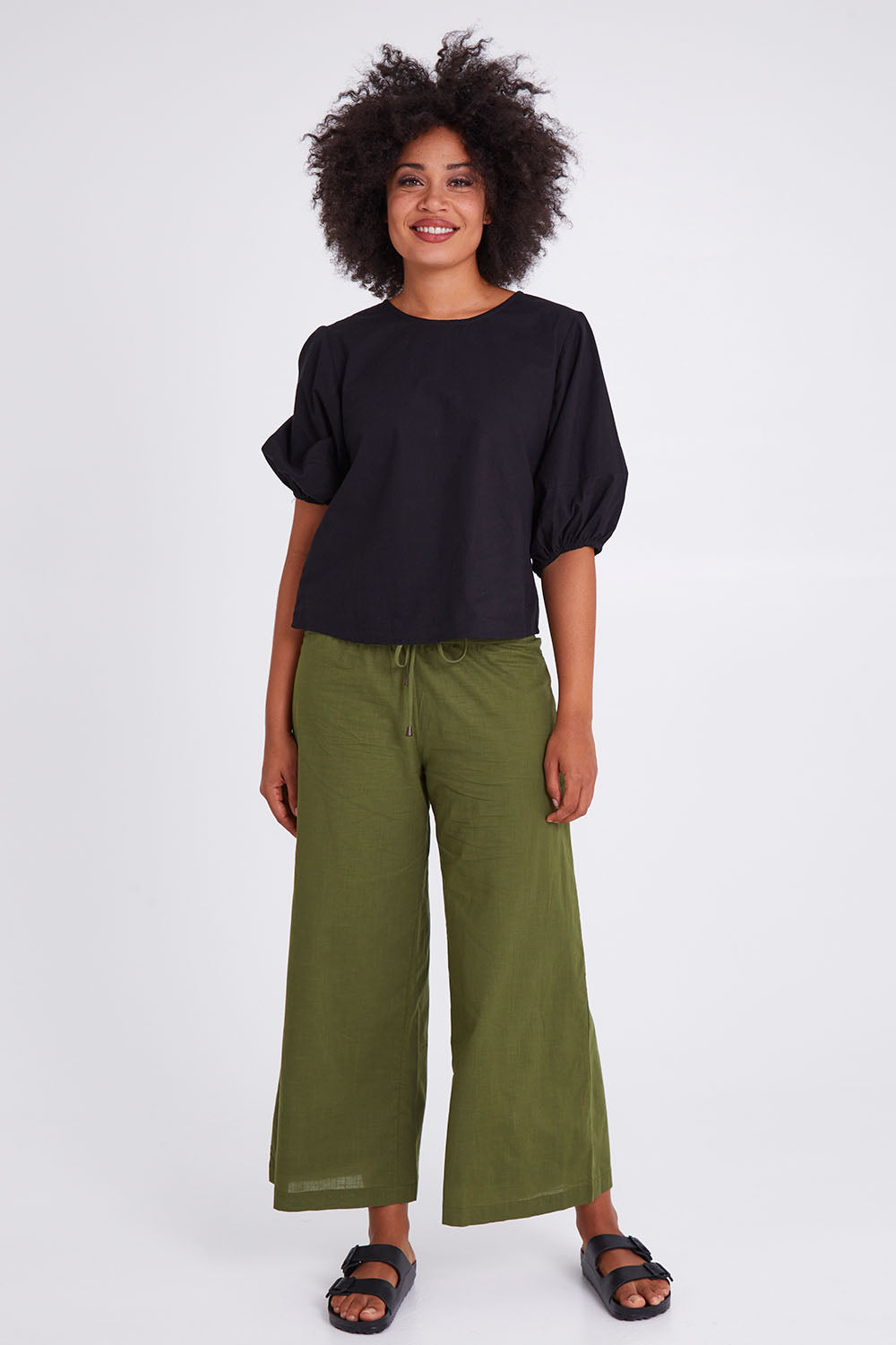 Model Olivia wearing size 10 of the Ava Top in colour Black (Black), from the front, showing the whole outfit
