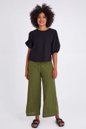 Model Olivia wearing size 10 of the Ava Top in colour Black (Black), from the front, showing the whole outfit