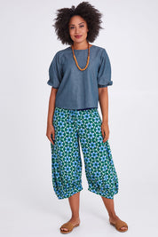 Model Olivia wearing size 10 of the Ava Top in colour Chambray (Blue), from the front, showing the whole outfit