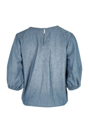Product shot of the Ava Top in colour Chambray (Blue), from the back