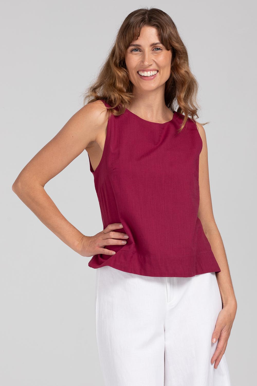A model wearing the Hara Cotton Top in colour Magenta (Purple), from the front, cropped image
