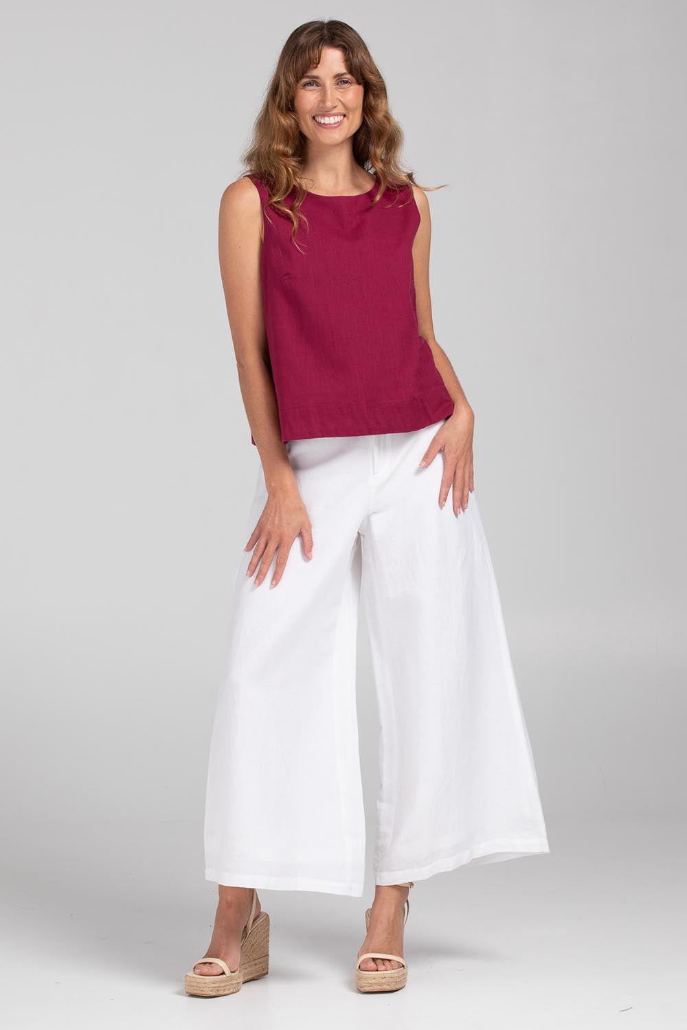 A model wearing the Hara Cotton Top in colour Magenta (Purple), from the front, showing the whole outfit
