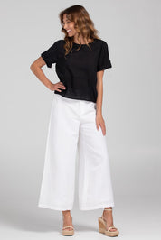 A model wearing the Guru Cotton Top in colour Black (Black), from the front, showing the whole outfit