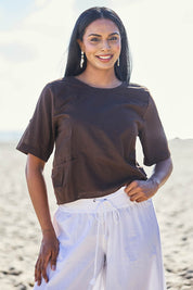 Model Eshan wearing size 10 of the Guru Cotton Top - Coffee in colour Coffee, in a cropped view