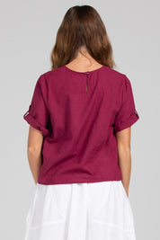 A model wearing the Guru Cotton Top in colour Magenta (Purple), from the back