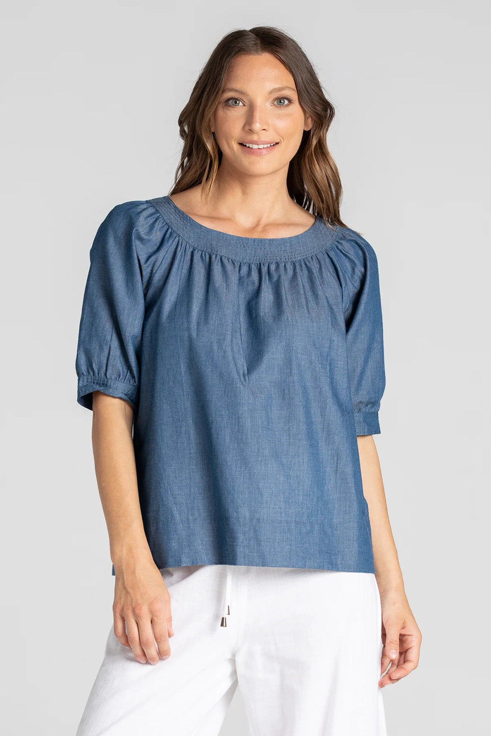 A model wearing the Bliss Top in colour Chambray (Blue), from the front, cropped image