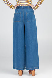 A model wearing the Brando Pant in colour Brando (Blue), from the back