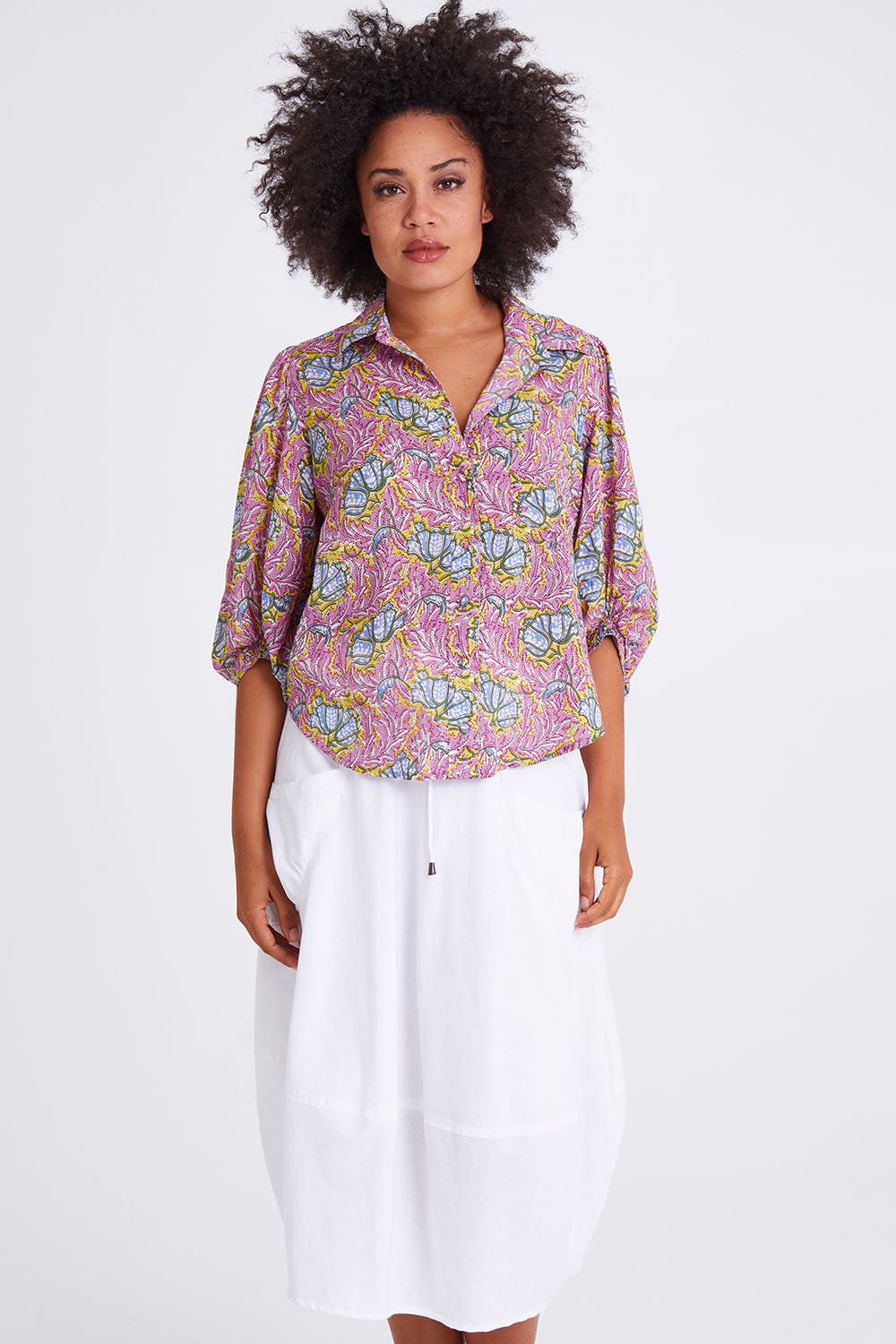 Model Olivia wearing size 10 of the Guru Skirt in colour White (White), from the front, cropped image