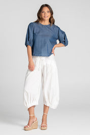 A model wearing the Guru Pant in colour White (White), from the front, showing the whole outfit