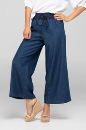 A model wearing the Ria Denim Pant in colour Darkdenim (Blue), from the front, cropped image
