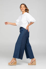 A model wearing the Ria Denim Pant in colour Darkdenim (Blue), from the front, showing the whole outfit