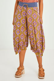 Model Olivia wearing size 10 of the Guru Pant in colour Amaira, from the front, cropped image