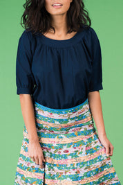 A model wearing the Bliss Top Basics in colour BlueBasic (Blue), from the front, cropped image