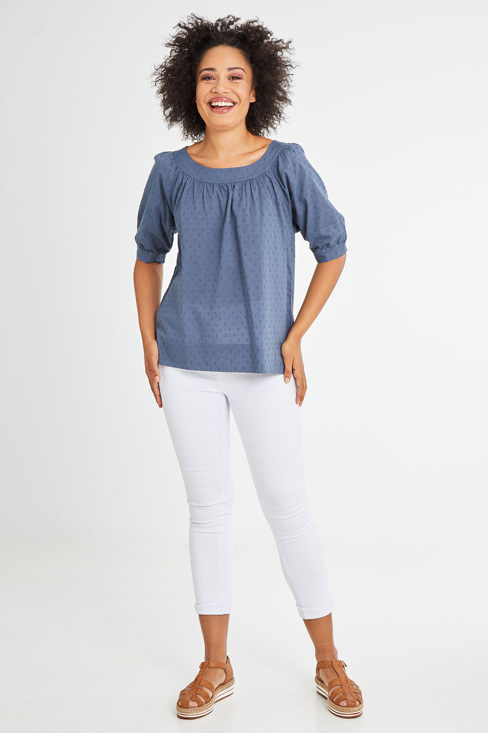Model Olivia wearing size 10 of the Bliss Top in colour Indiansea (Blue), from the front, showing the whole outfit
