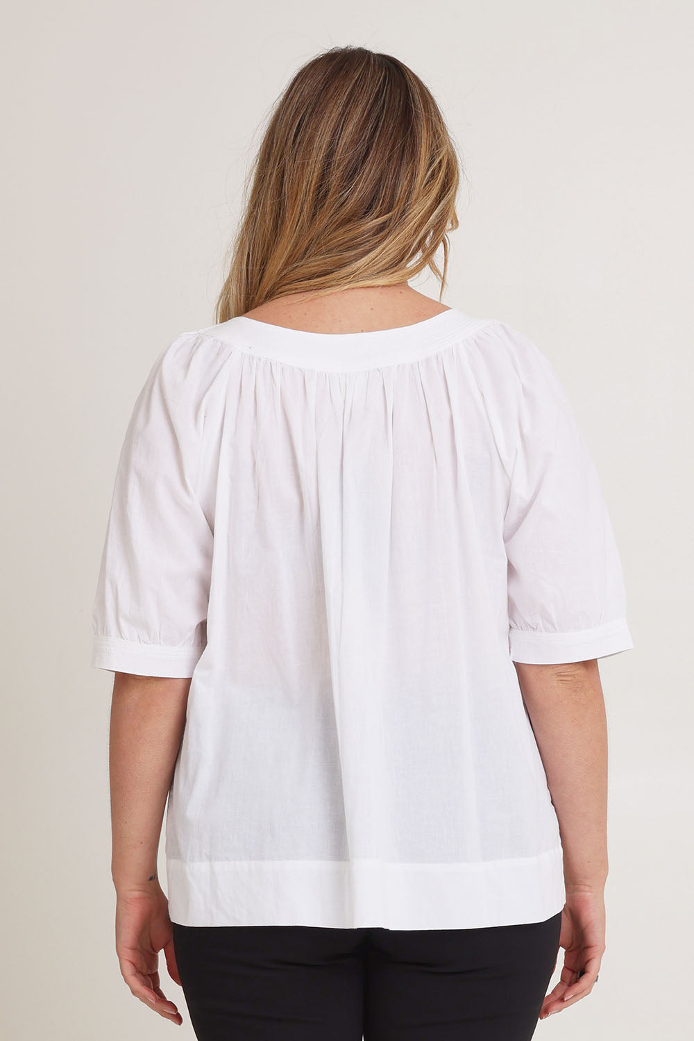Model Chanel wearing size 16 of the Bliss Top in colour White (White), from the back